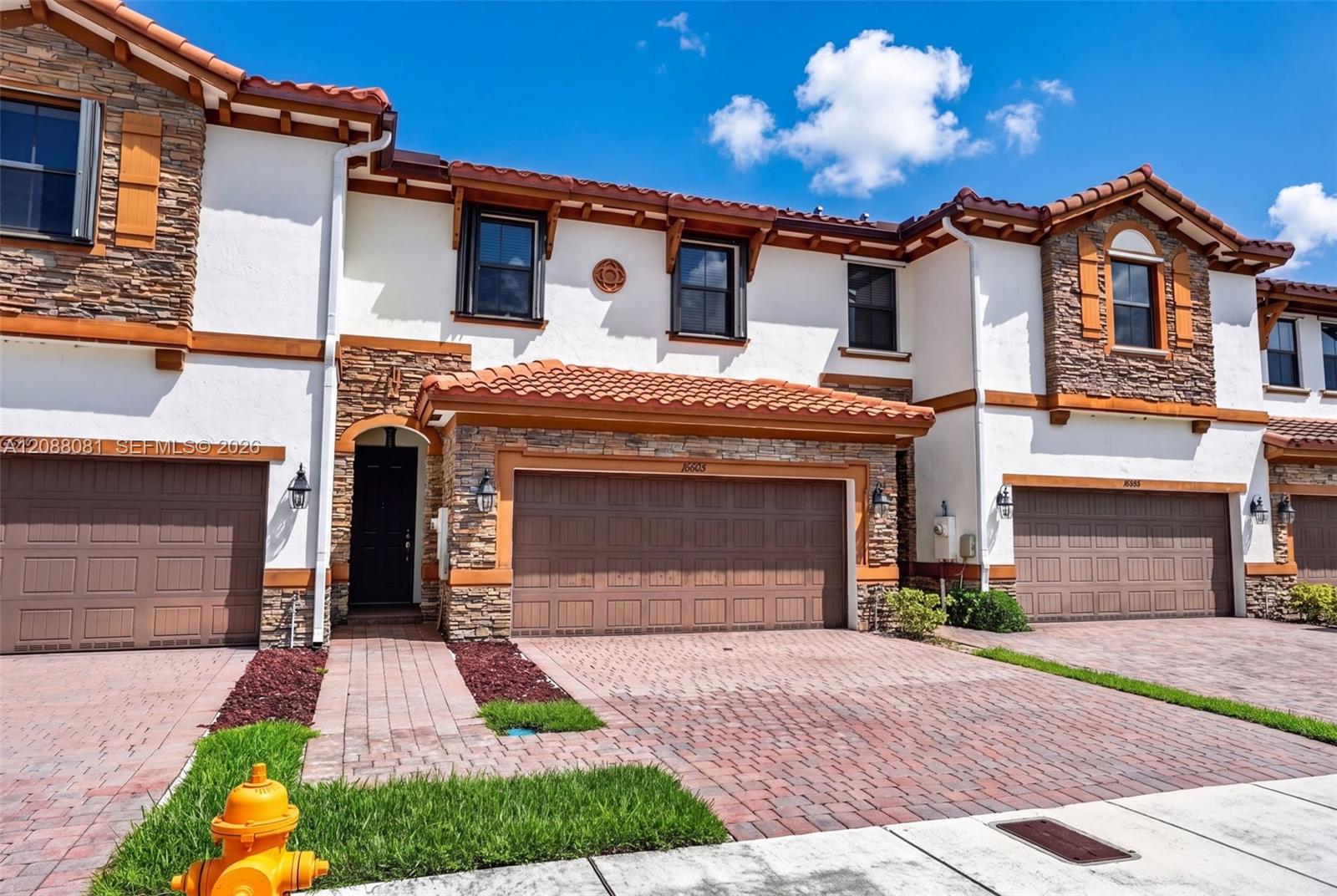 Front exterior and paver driveway